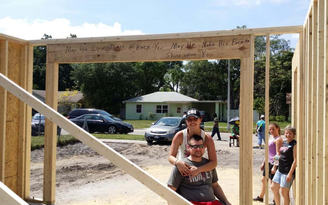 Habitat homeowners pose at a construction site.