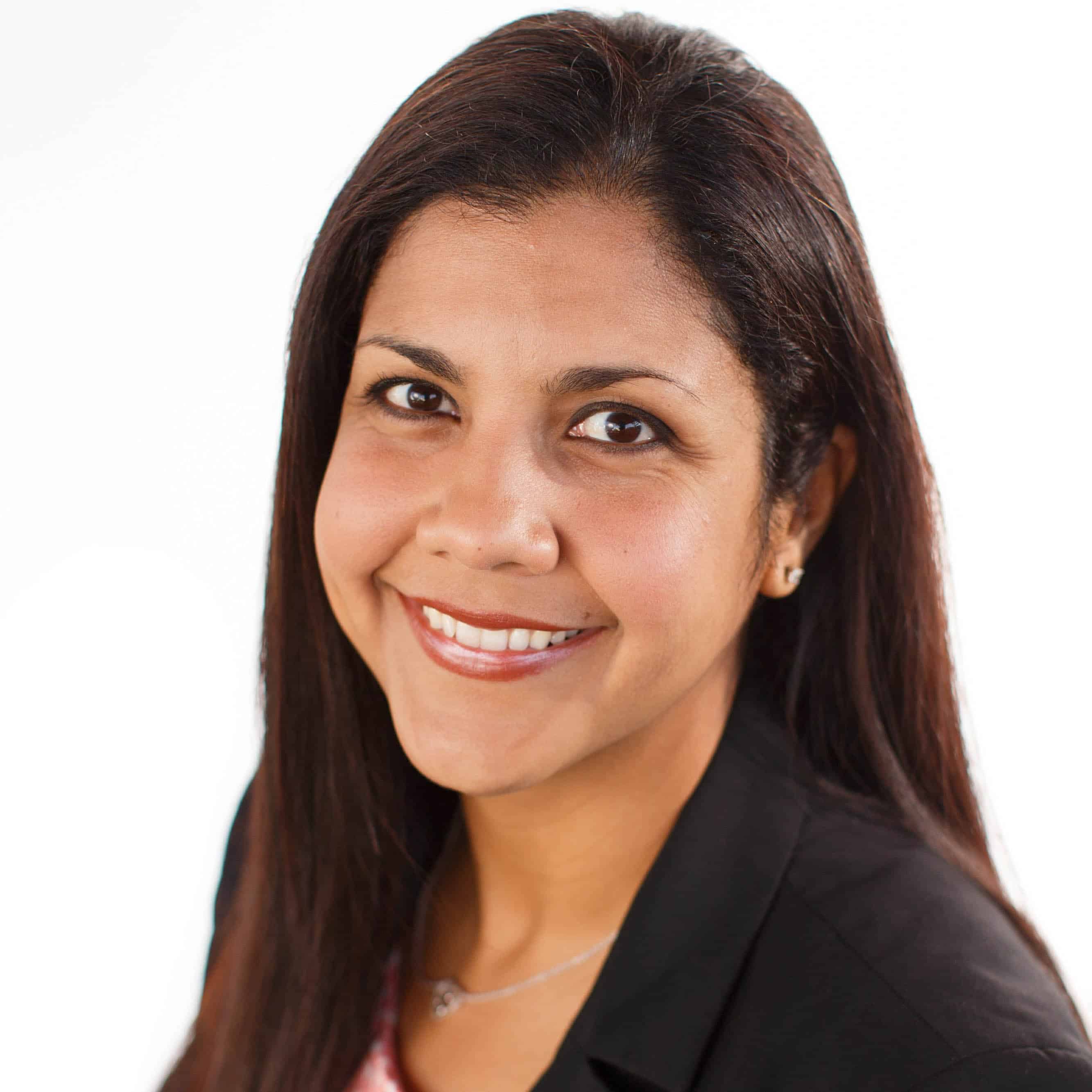 Business woman smiling at camera in front of white background