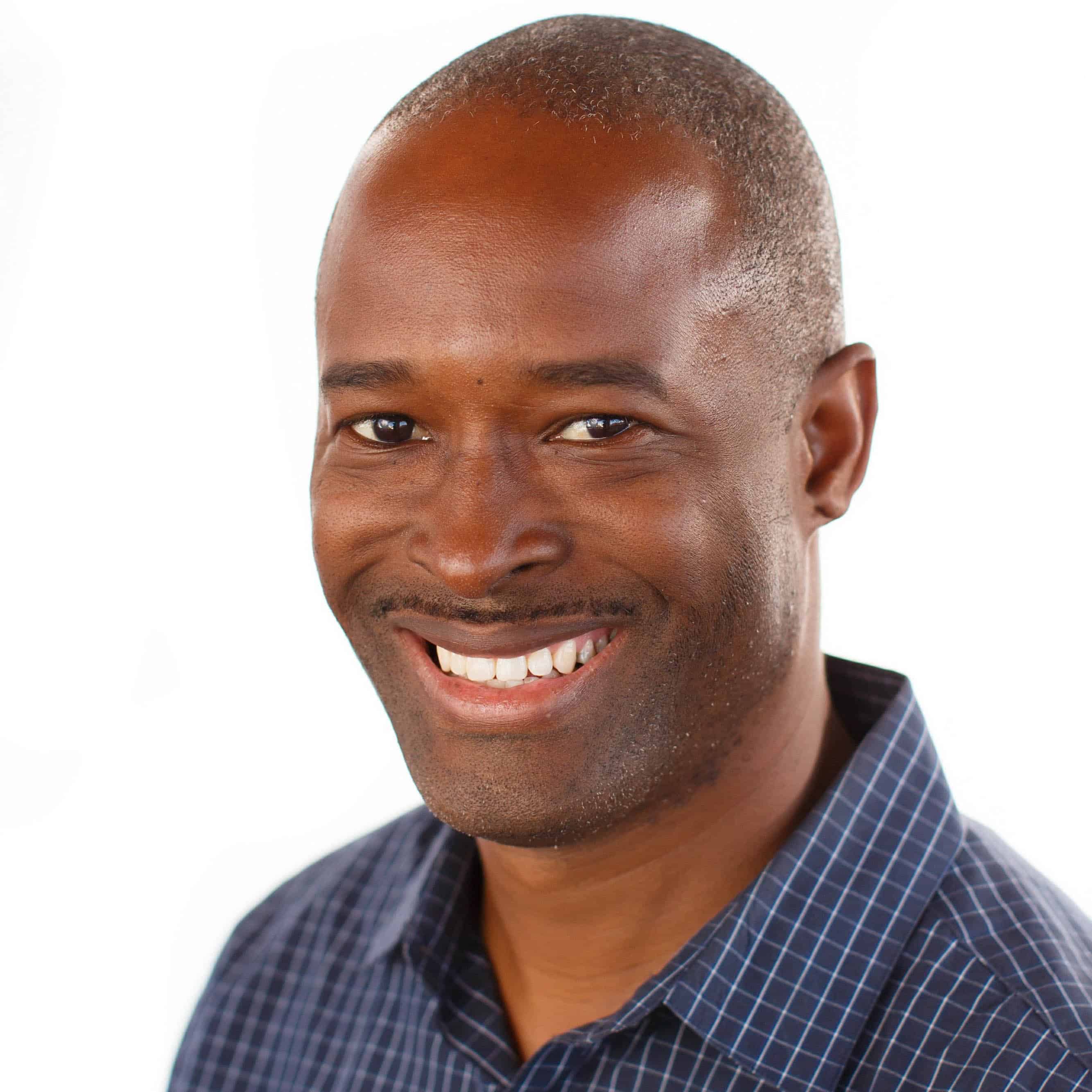 Business man smiling at camera in front of white background