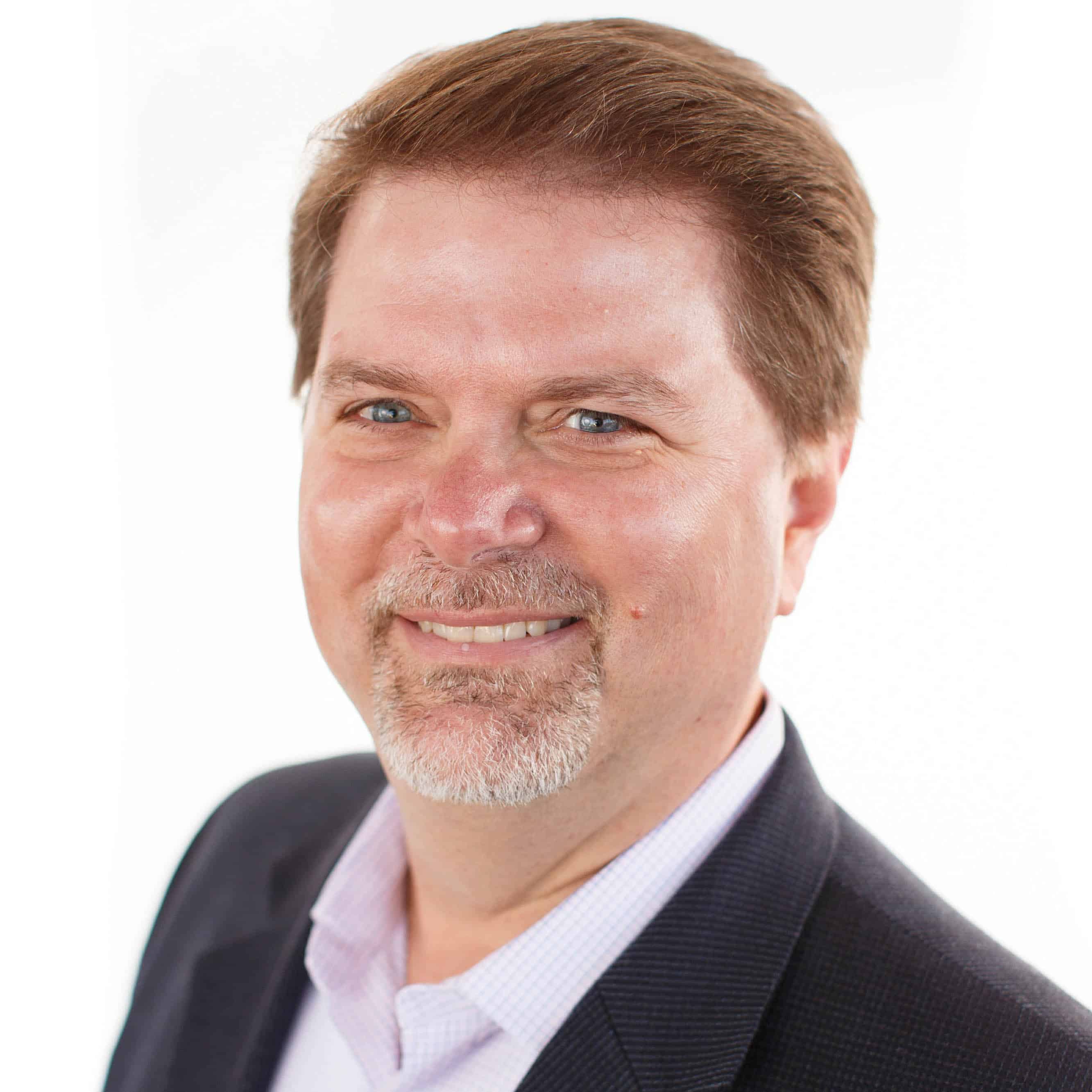 Business man smiling at camera in front of white background