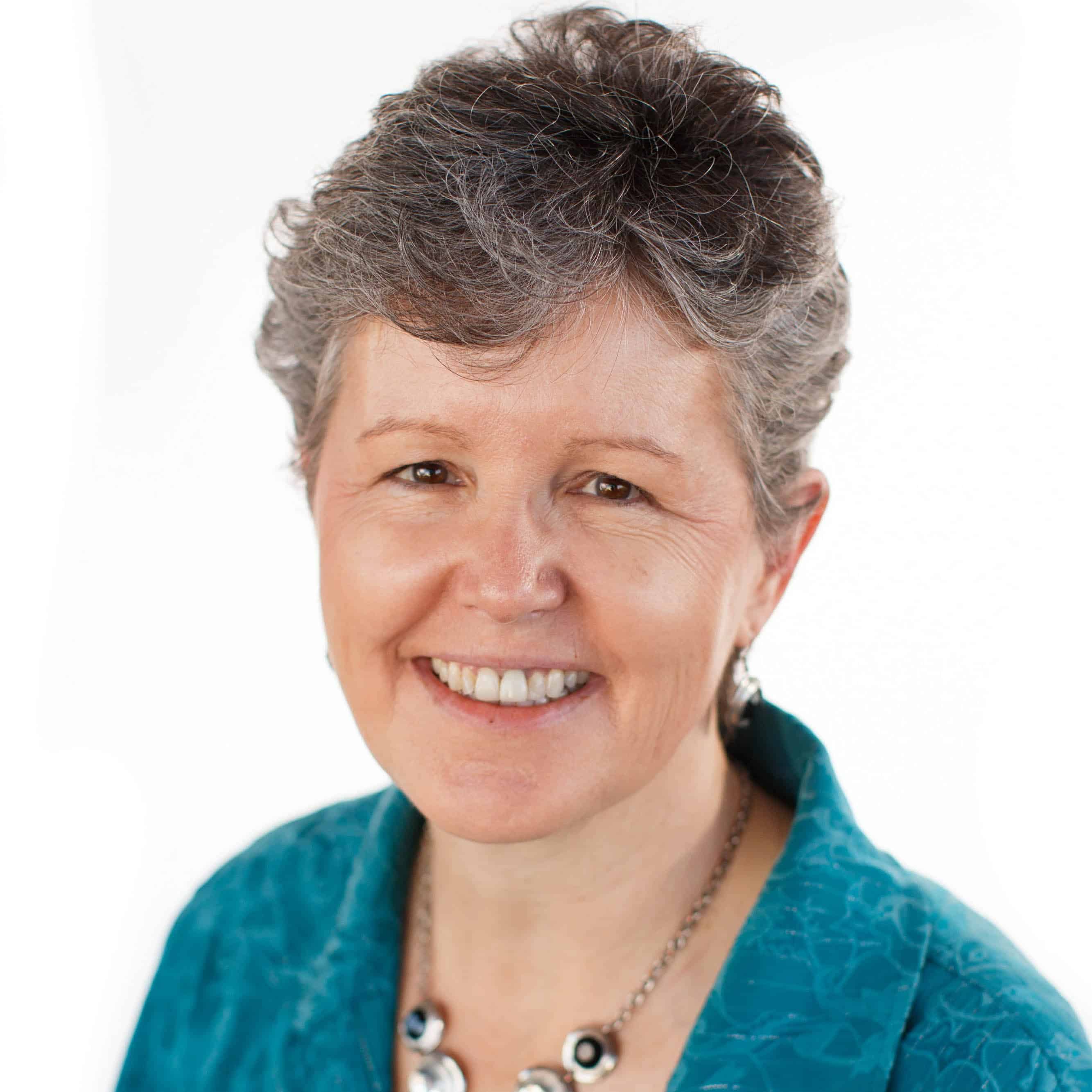 Business woman smiling at camera in front of white background