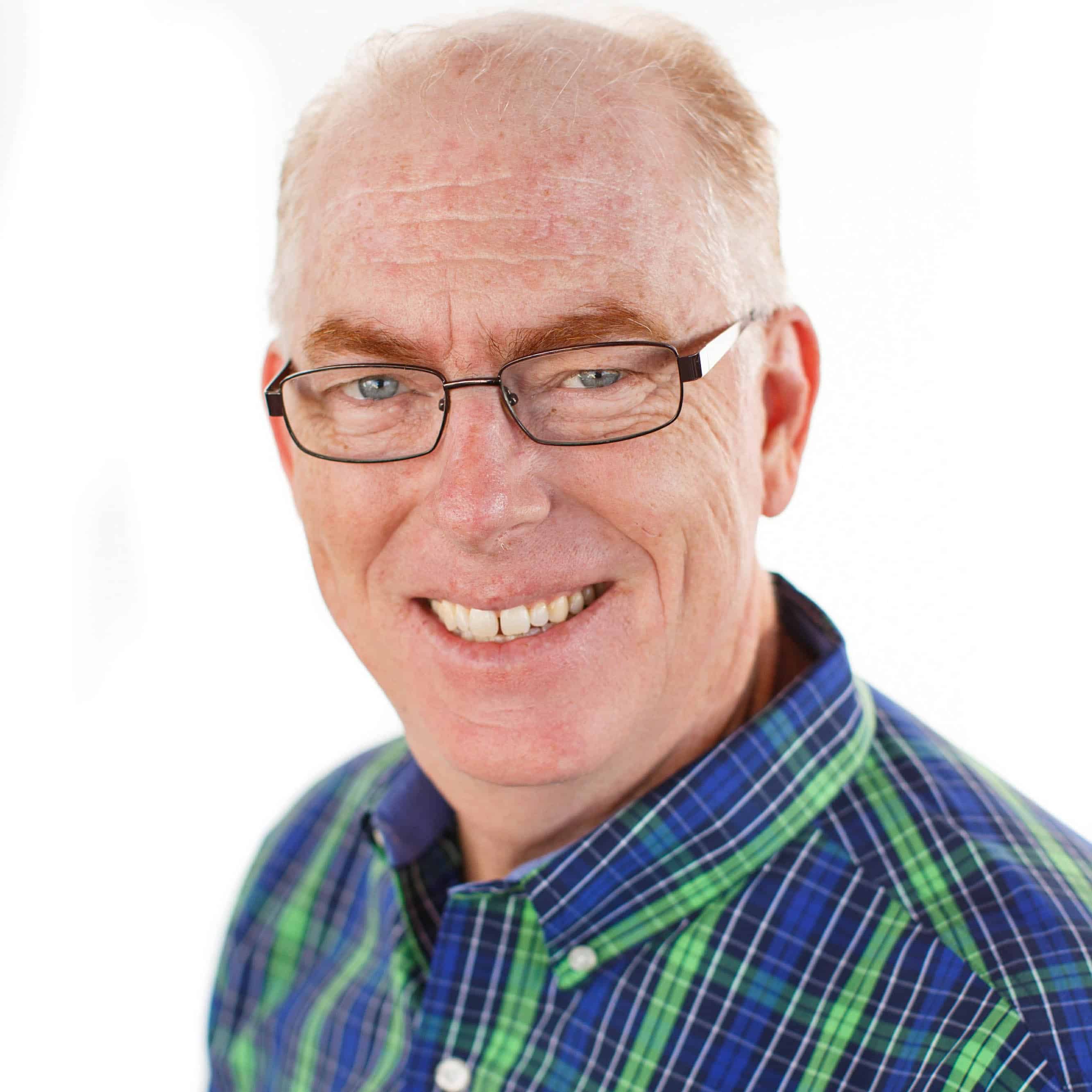 Business man smiling at camera in front of white background