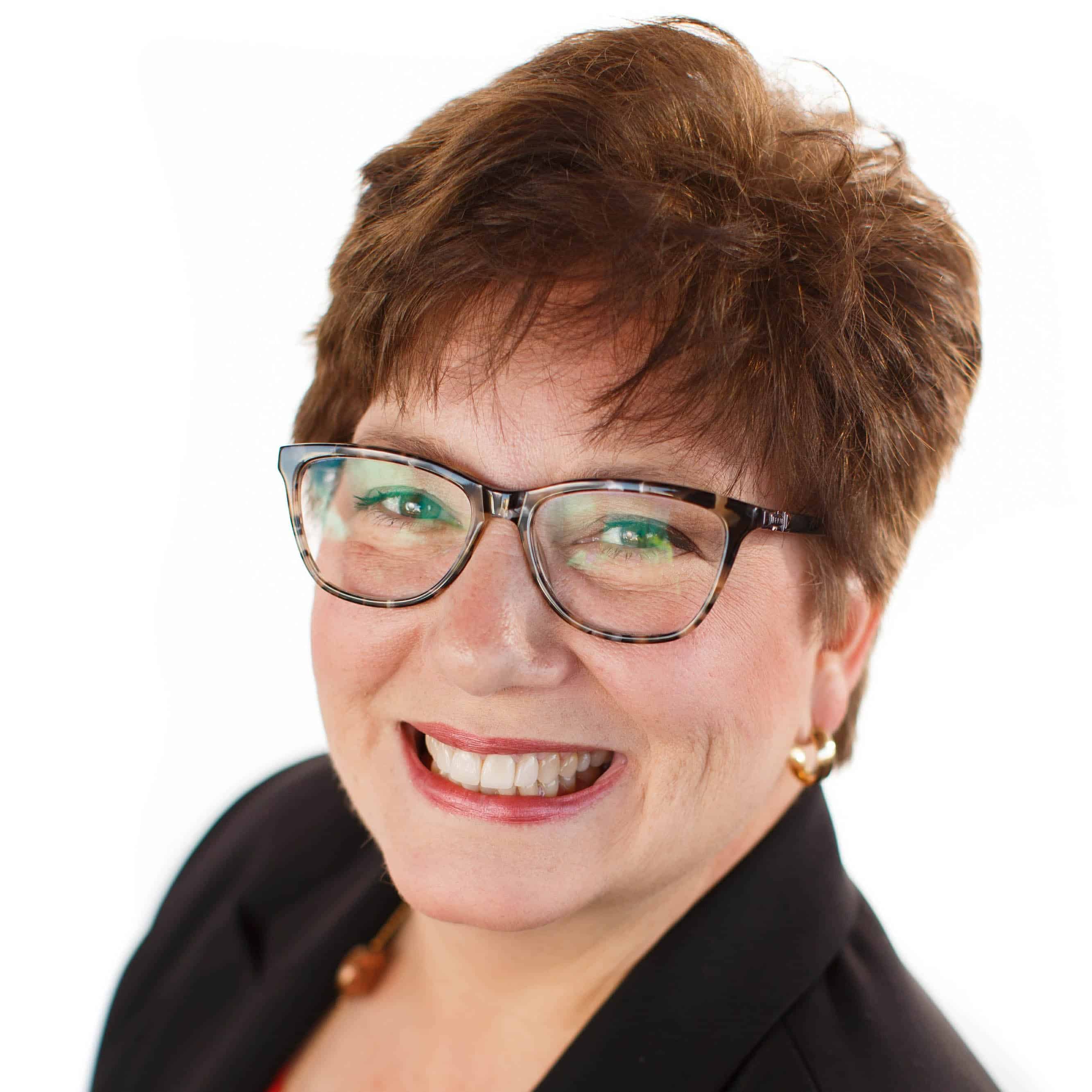 Business woman smiling at camera in front of white background