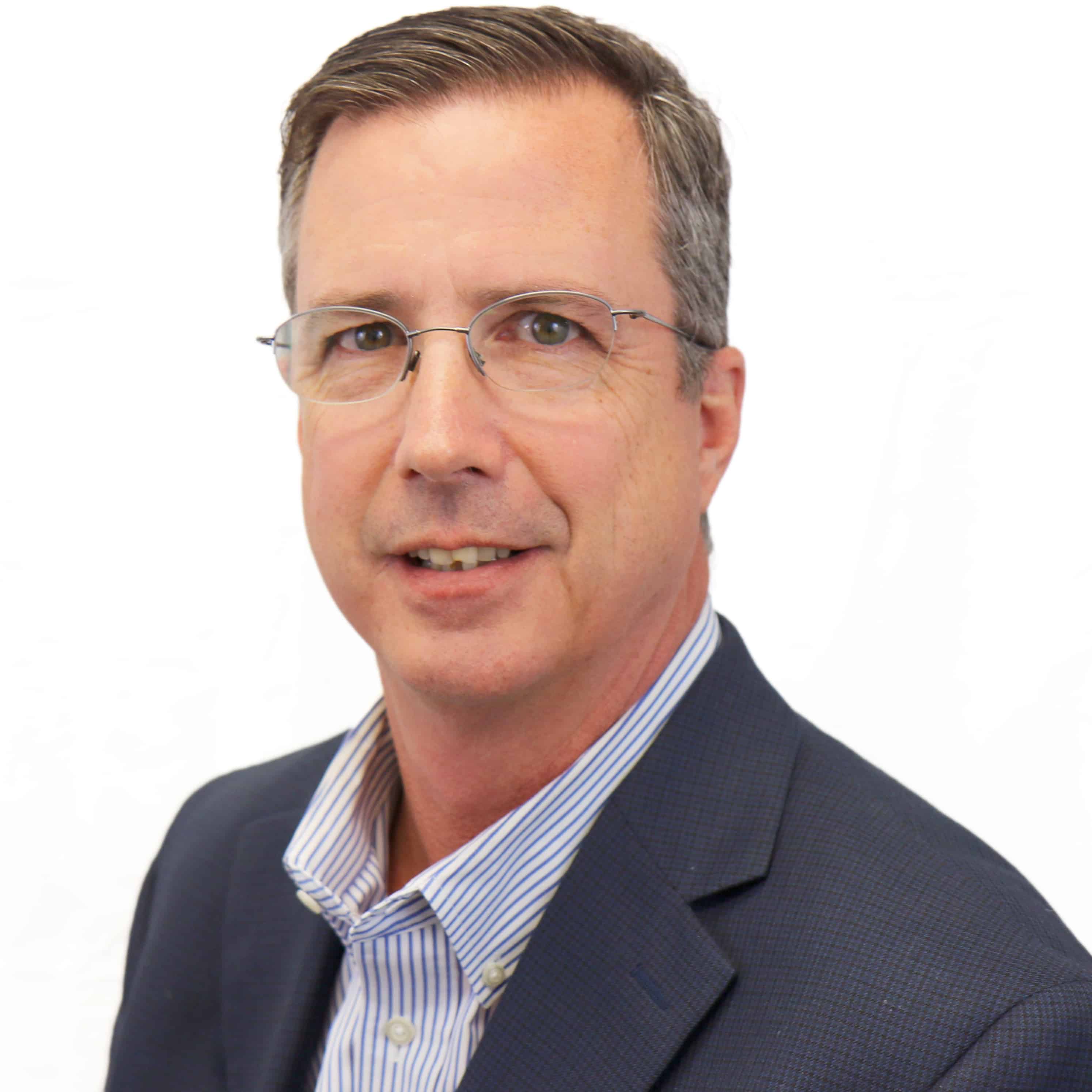 Business man smiling at camera in front of white background