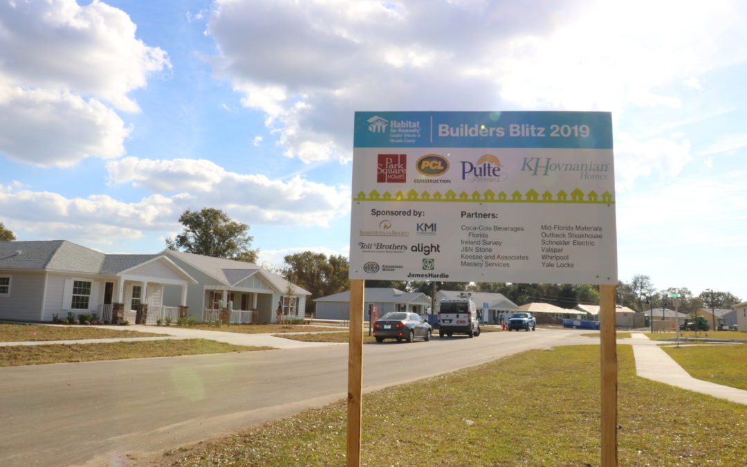 Builders Blitz 2019 sign in front of row of new houses