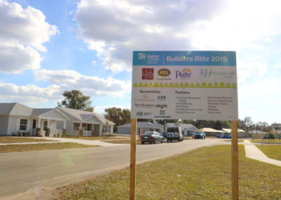 Builders Blitz 2019 sign in front of row of new houses