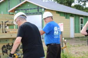 Crew leader Bill explains a task to a volunteer at a Habitat Orlando & Osceola build site. 