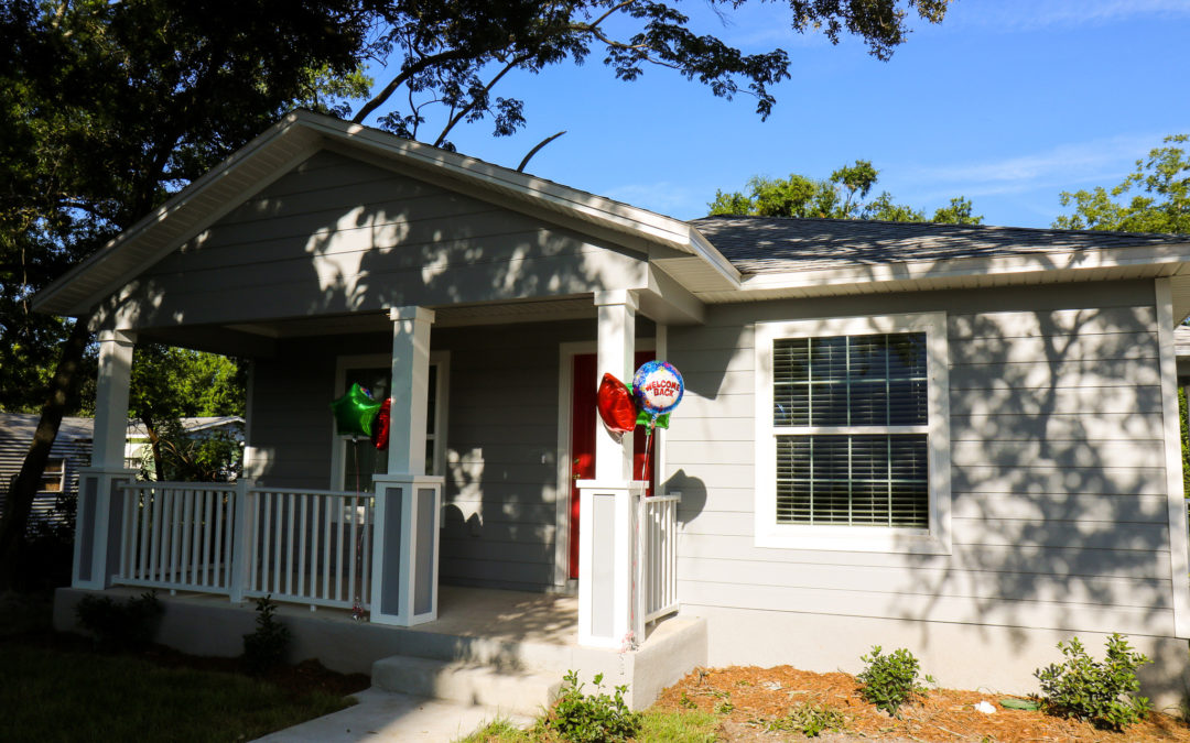 The front of a gray affordable home.