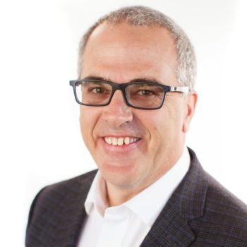 Business man smiling at camera in front of white background