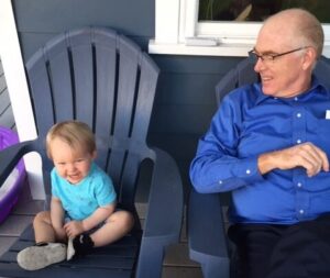 Habitat board chair Pete Barr, Jr., right, sits with his grandson