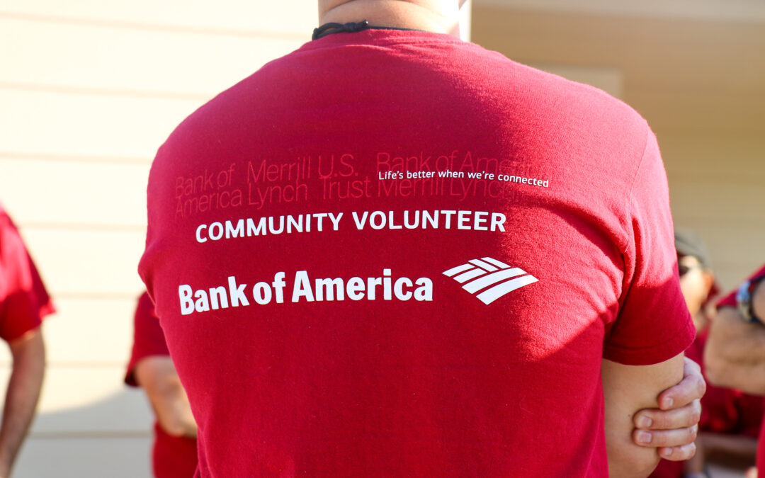 A man stands with his back to the camera wearing a Bank of America shirt.