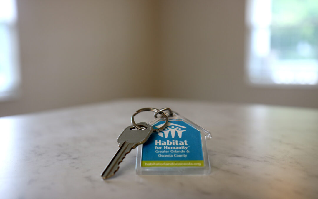 A key on a Habitat Orlando & Osceola keychain