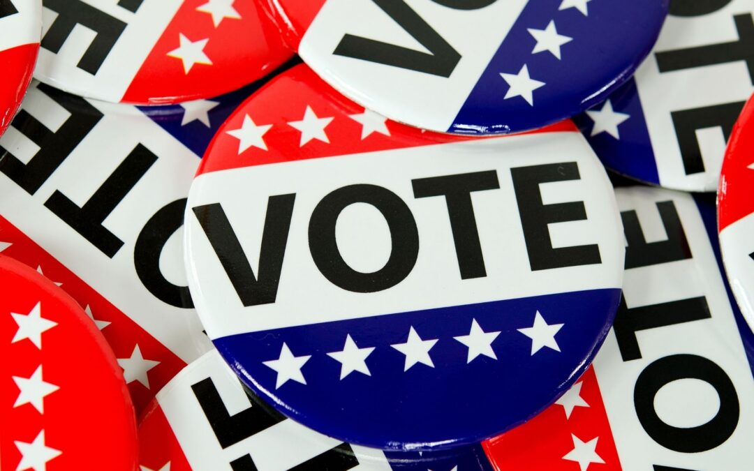 Red, white and blue buttons reading "Vote" for Election Day.