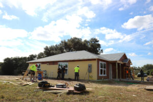 Construction workers work on a Habitat home