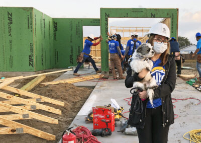 Woman with dog in front of active construction site
