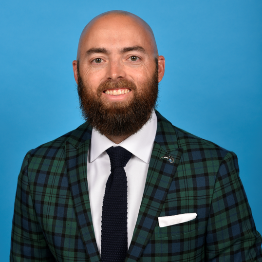 Business man smiling at camera in front of white background