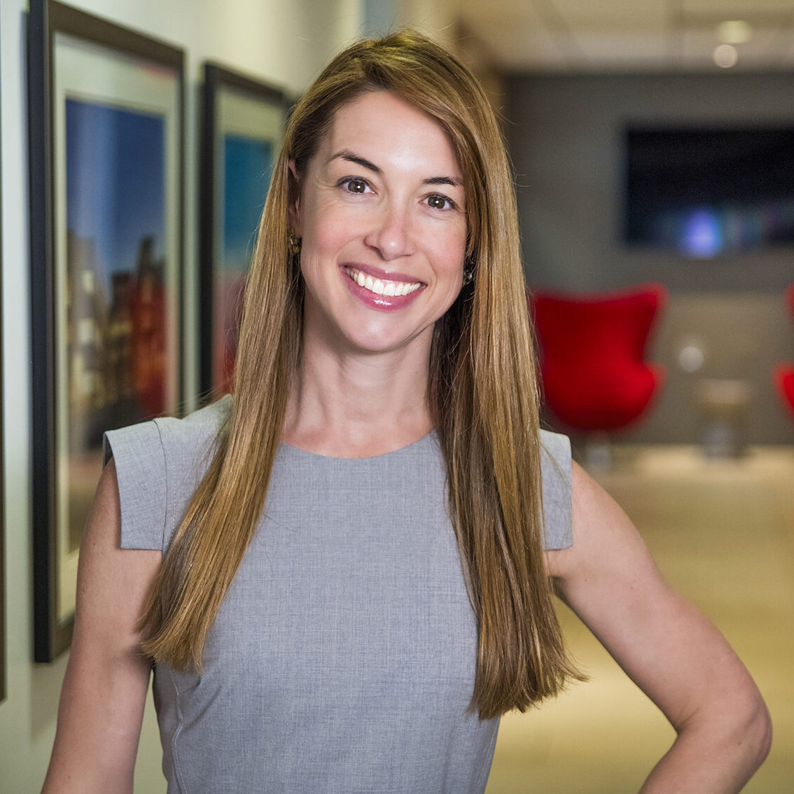 Business woman smiling at camera in front of white background