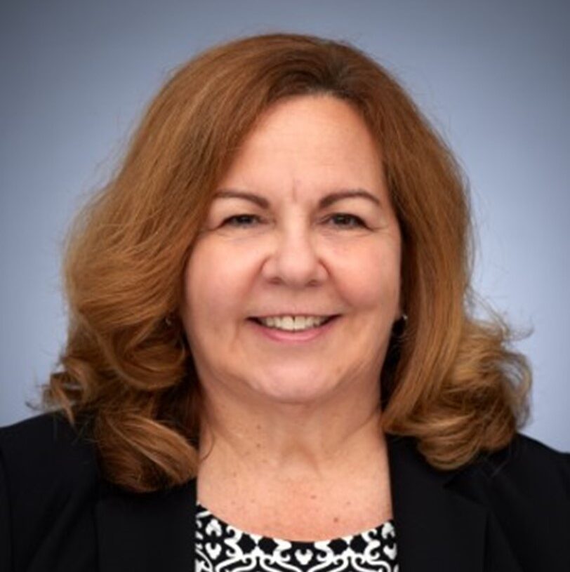 Business woman smiling at camera in front of white background