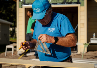 A crew leader volunteers on a build site.